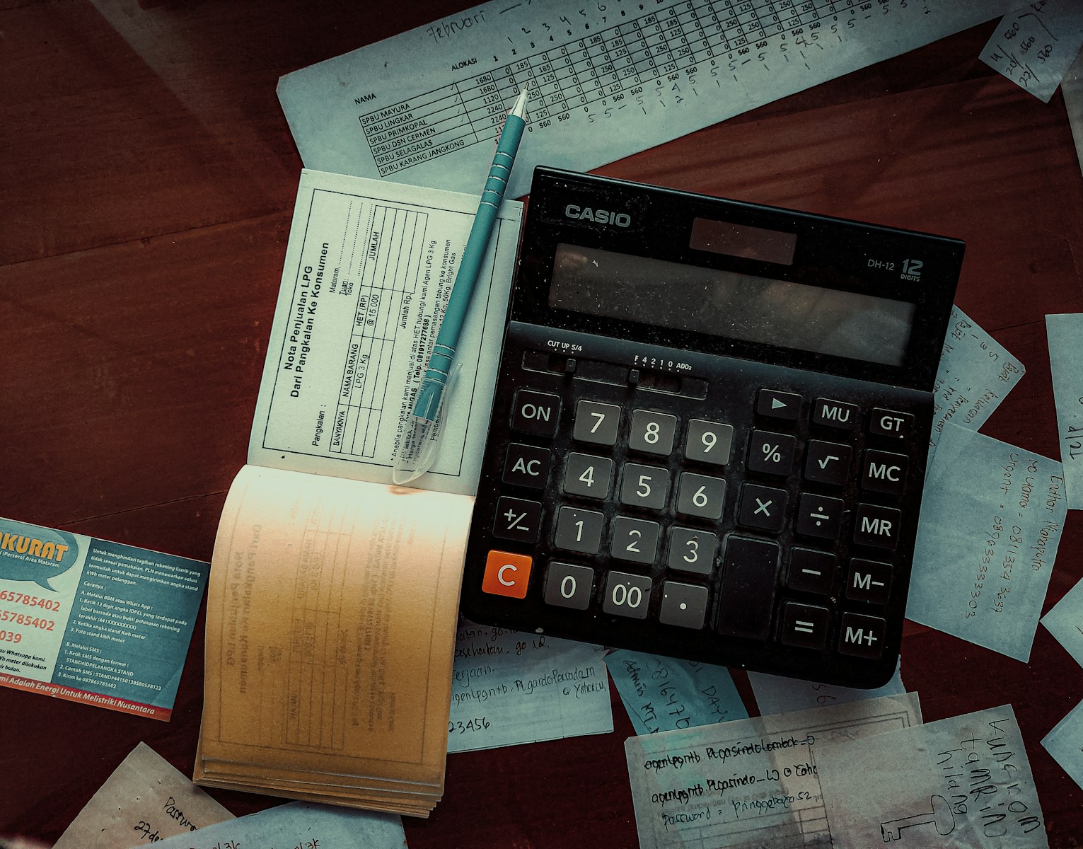Photo by FIN a calculator sitting on top of a wooden table small business bookkeeping