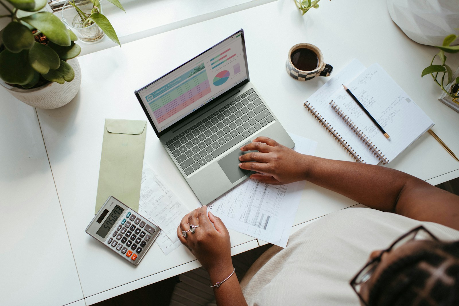 a person sitting at a table with a laptop social media for business