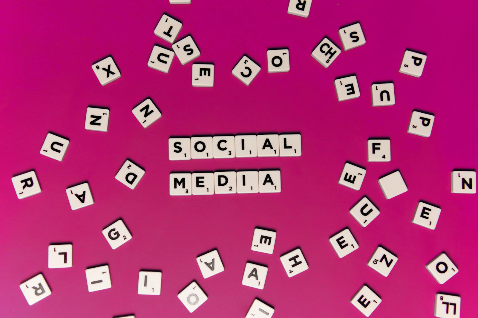 Alphabet tiles forming 'Social Media' on a vibrant pink background, perfect for digital marketing themes. 8 (Social Media Branding) Moves to Announce Your New Brand Identity
