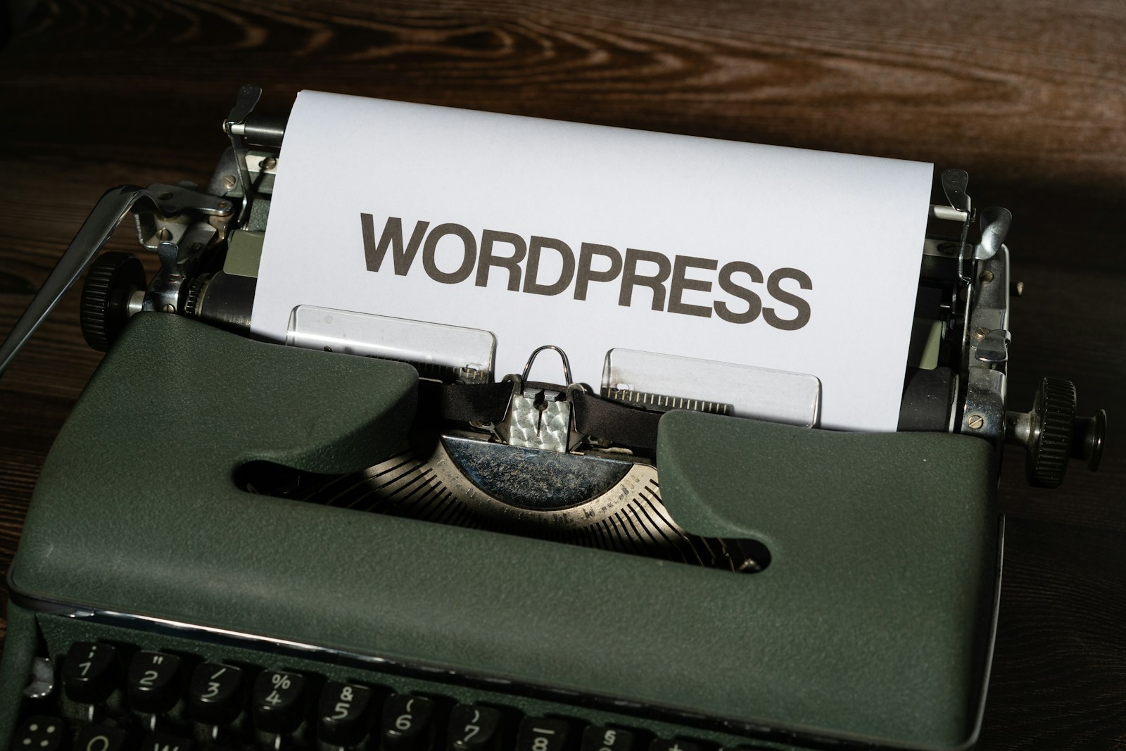 a close up of a typewriter with the word wordpress printed on it WordPress Maintenance Plans: The Foundation Every Serious Website Needs in 2026