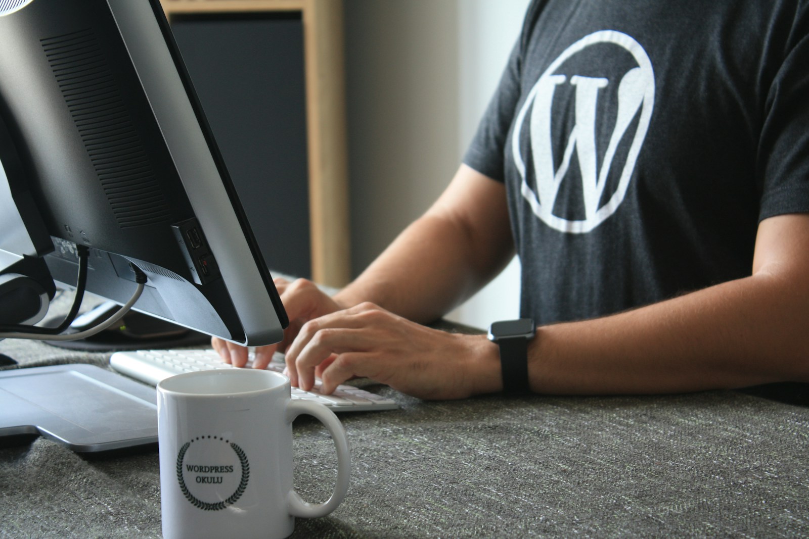 person in black and white t-shirt using computer (WordPress SEO Company): What to Look for When Growing Your Site this New Year